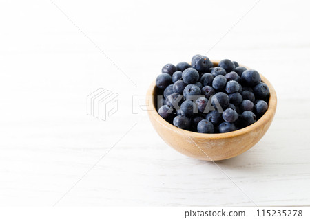 Ripe organic blueberries on white wooden table background. Selective focus. Ripe organic blueberries on white wooden table background. Selective focus. 115235278
