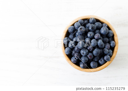 Ripe organic blueberries on white wooden table background. Selective focus. Ripe organic blueberries on white wooden table background. Selective focus. 115235279