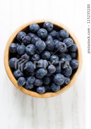 Ripe organic blueberries on white wooden table background. Selective focus. Ripe organic blueberries on white wooden table background. Selective focus. 115235280