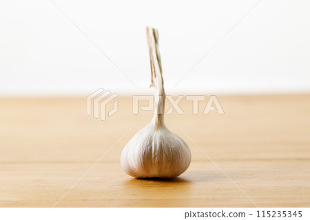 Ripe organic garlic clove and bulb on wooden background.  Close-up. Selective focus. 115235345