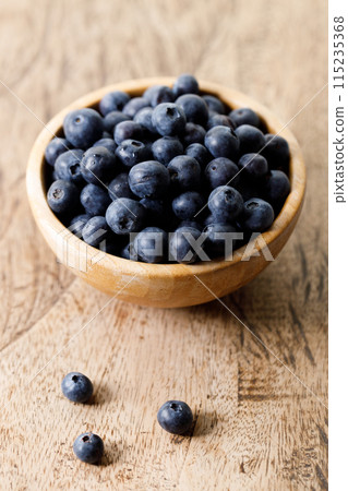 Ripe organic blueberries on wooden table background. Selective focus. 115235368
