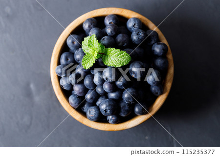 Ripe organic blueberries on black stone table background. Selective focus. 115235377