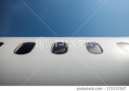 Windows on fuselage of airplane. 115235507