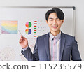 A young male office worker giving a presentation using a pie chart 115235579