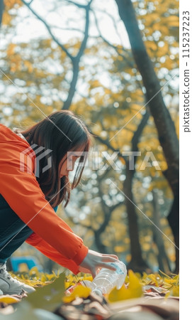 A girl removes plastic bottles and garbage in the forest, taking care of the cleanliness of the forest A girl removes plastic bottles and garbage in the forest, taking care of the cleanliness of the forest 115237223