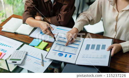 Business colleague reading financial budget document to brainstorming and analysis business project 115237226