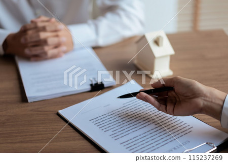 Real estate agent woman explains about house purchase contract and house insurance policy to client Real estate agent woman explains about house purchase contract and house insurance policy to client 115237269