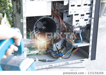Cleaning a dusty computer with a blower. Cleaning a dusty computer with a blower. 115238208