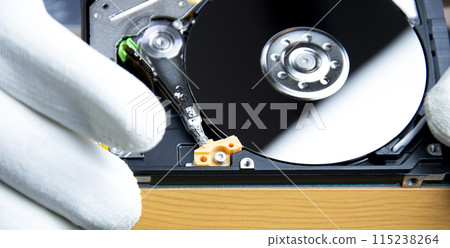 mechanic repairing hard drive, hard drive It is a device for storing data. mechanic repairing hard drive, hard drive It is a device for storing data. 115238264