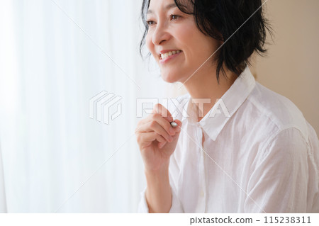 中年婦女在客廳寫信 115238311