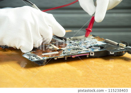 side view mechanic repairing motherboard 115238403