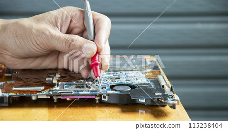 side view mechanic repairing motherboard 115238404
