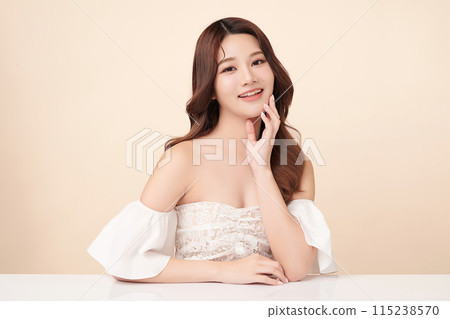 Beautiful young asian woman with clean fresh skin on beige background, Face care, Facial treatment, Cosmetology, beauty and spa, Asian women portrait. Beautiful young asian woman with clean fresh skin on beige background, Face care, Facial treatment, Cosmetology, beauty and spa, Asian women portrait. 115238570