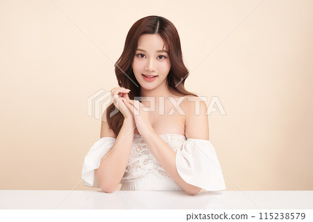 Beautiful young asian woman with clean fresh skin on beige background, Face care, Facial treatment, Cosmetology, beauty and spa, Asian women portrait. Beautiful young asian woman with clean fresh skin on beige background, Face care, Facial treatment, Cosmetology, beauty and spa, Asian women portrait. 115238579