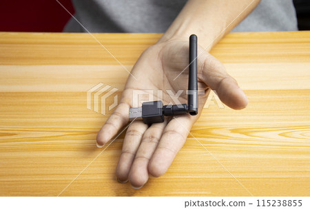 USB wifi black on hand, hand holding usb wifi USB wifi black on hand, hand holding usb wifi 115238855