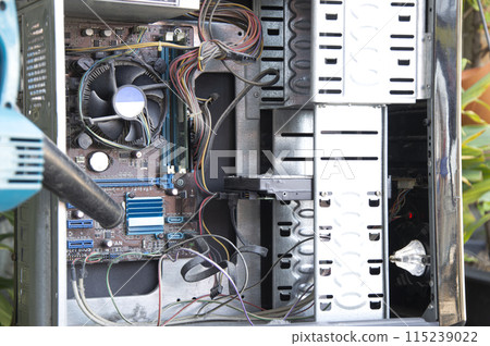 Cleaning a dusty computer with a blower. Cleaning a dusty computer with a blower. 115239022