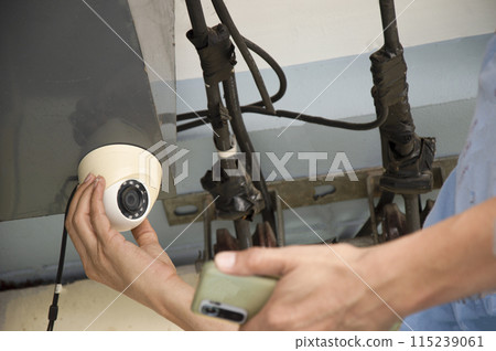 Conceptual man operating ip camera Conceptual man operating ip camera 115239061