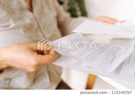 woman's hands holding an envelope with a letter woman's hands holding an envelope with a letter 115240767