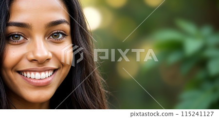 banner with close-up young, healthy, happy, beautiful, dark-skinned, mulatto woman, smiling, looking at the camera among the trees, on blurred, green, natural, sunny, vegetative copy space background 115241127