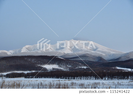 Blue winter sky and snow-covered Mount Shari 115241422