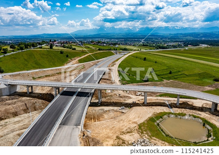 Drone shot of the highway construction from Krakow to Zakopane in the summer. Drone shot of the highway construction from Krakow to Zakopane in the summer. 115241425