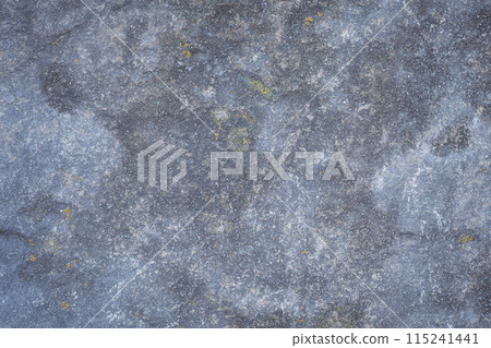 A fragment of a blue-gray stone with rosettes of lichen, natural rock background. A fragment of a blue-gray stone with rosettes of lichen, natural rock background. 115241441