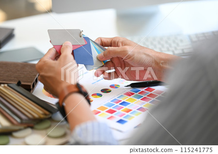 Close up Interior designer holding color samples working on new design project at office 115241775