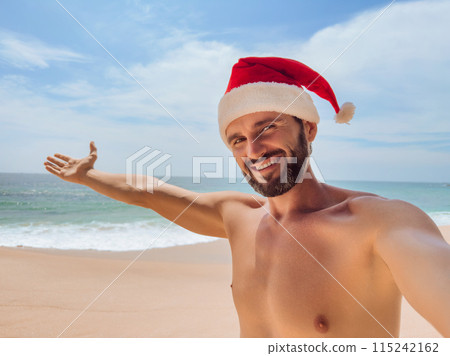 Cheerful Man in Santa Hat Enjoying Beach Holiday 115242162