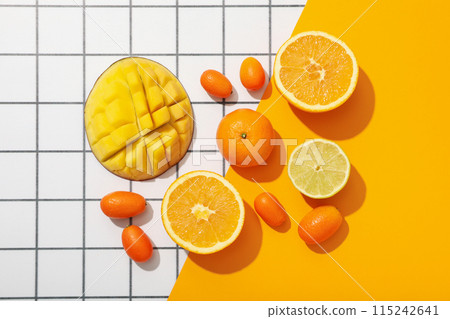 Set of tropical fruits on white and yellow background, top view 115242641