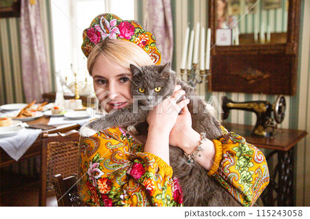 Portrait of a beautiful Russian girl in a kokoshnik and traditional dress 115243058