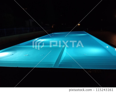 swimming pool illuminated at night outdoors swimming pool illuminated at night outdoors 115243161