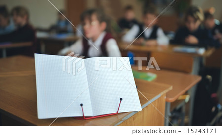 Notebook on a stand in the classroom during a lesson. 115243171