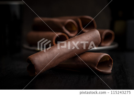 Chocolate Covered Wafers on a Dark Tabletop Chocolate Covered Wafers on a Dark Tabletop 115243275