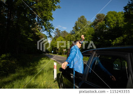 A stopover in the forest on the side of the road during long journeys by passenger car for a dream vacation. A stopover in the forest on the side of the road during long journeys by passenger car for a dream vacation. 115243355