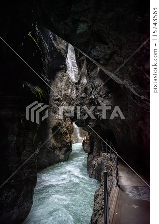 Hiking through the scenic Partnach gorge near Garmisch-Partenkirchen in the Bavarian Alps 115243563