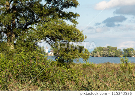View from Herreninsel to the Monastery on Fraueninsel Island View from Herreninsel to the Monastery on Fraueninsel Island 115243586