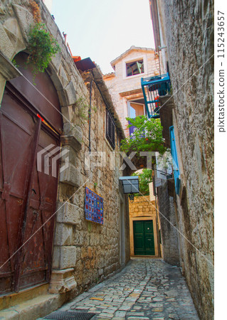 Scenic narrow, typical mediterranean alley in downtown Trogir Scenic narrow, typical mediterranean alley in downtown Trogir 115243657