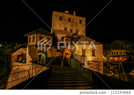 Famous rebuilt historic bridge in downtown Mostar at night 115243668