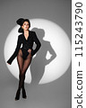 Beautiful woman in retro style in a black bodysuit and a bow in her hair in full length posing on a gray background. Beauty of body and face 115243790