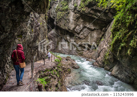 Hiking through the scenic Partnach gorge near Garmisch-Partenkirchen in the Bavarian Alps 115243996