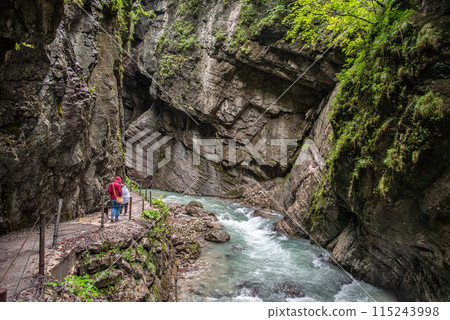 Hiking through the scenic Partnach gorge near Garmisch-Partenkirchen in the Bavarian Alps Hiking through the scenic Partnach gorge near Garmisch-Partenkirchen in the Bavarian Alps 115243998