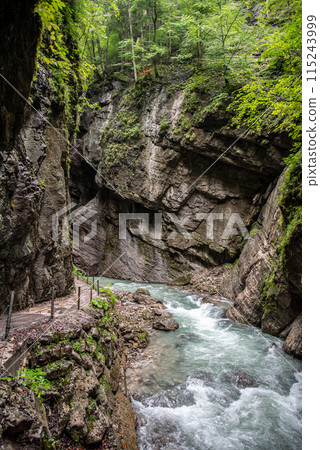 Hiking through the scenic Partnach gorge near Garmisch-Partenkirchen in the Bavarian Alps 115243999