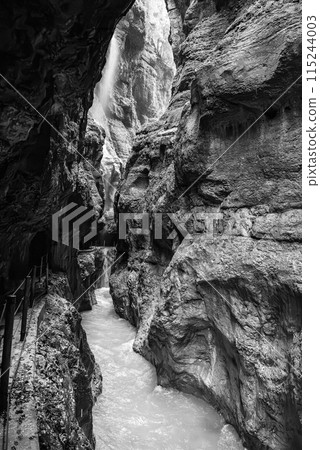 Hiking through the scenic Partnach gorge near Garmisch-Partenkirchen in the Bavarian Alps 115244003