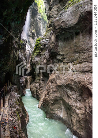 Hiking through the scenic Partnach gorge near Garmisch-Partenkirchen in the Bavarian Alps Hiking through the scenic Partnach gorge near Garmisch-Partenkirchen in the Bavarian Alps 115244004