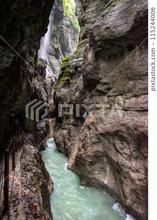 Hiking through the scenic Partnach gorge near Garmisch-Partenkirchen in the Bavarian Alps 115244006