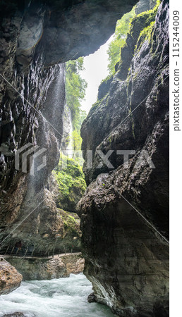 Hiking through the scenic Partnach gorge near Garmisch-Partenkirchen in the Bavarian Alps 115244009