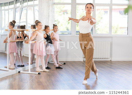 Female teacher shows choreography to group of girls Female teacher shows choreography to group of girls 115244361
