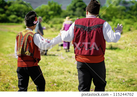 Men dancing dressed in traditional clothing. Annual Rose picking ritual in Bulgaria 115244702