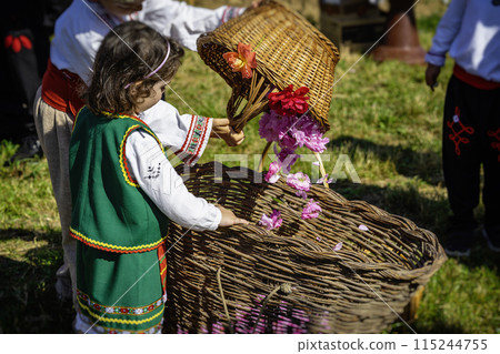 Little girl dressed in traditional dress with basket of rose petals, Annual Rose Festival in Kazanlak, Bulgaria Little girl dressed in traditional dress with basket of rose petals, Annual Rose Festival in Kazanlak, Bulgaria 115244755