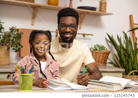 Young dad explaining kid daughter learning doing homework Young dad explaining kid daughter learning doing homework 115245743